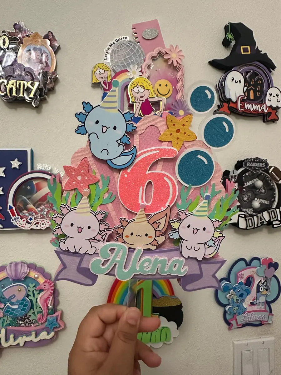 Axolotl birthday cake topper among other finished toppers
